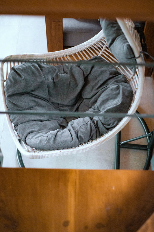 a pair of grey pants on a white chair