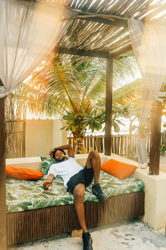 woman in black tank top and black shorts lying on bed