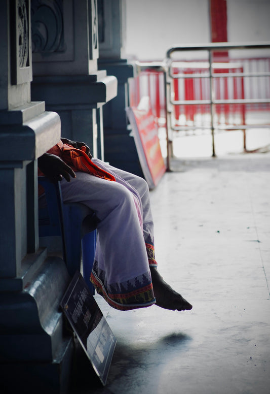 A person sitting on a bench in a building